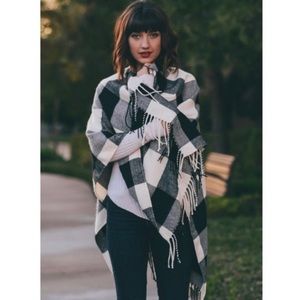 Black and white plaid poncho with fringe.